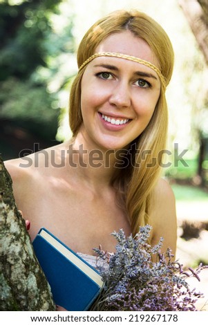 Beautiful woman reading a book in the garden