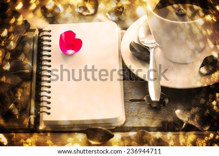 Note Pad and Pencil with flowers on Wood Table Surface.Christmas light