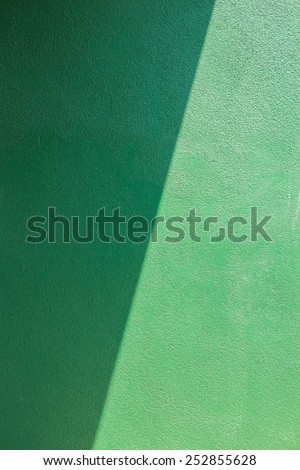Green wall of cement.light and shadow