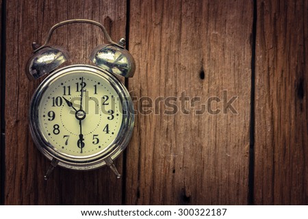 Vintage with alarm clock on wood