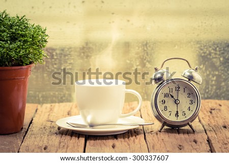 Steaming coffee cup on a rainy day window background,good time of coffee