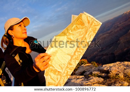 Female explorer with a map at the Grand Canyon