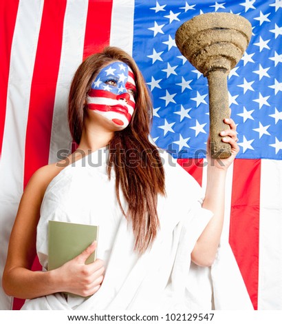 American woman dressed as the Statue of Liberty with the USA flag painted on her face