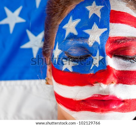 American woman with the USA flag painted on his face