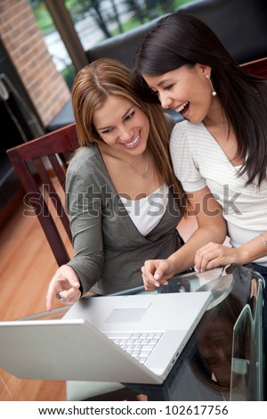 Women at home working on a laptop computer and looking surprised