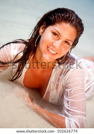 Sexy woman at the beach with a wet t-shirt