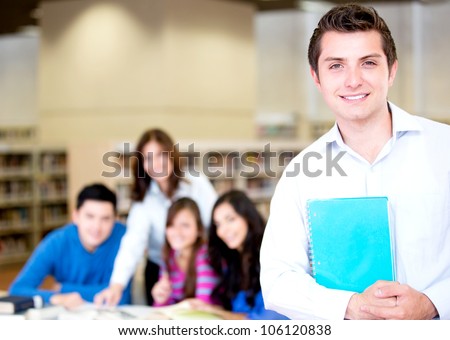 College male student with a group at the library