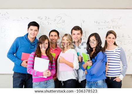 Group of students smiling and holding notebooks