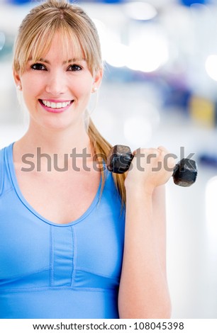 Woman exercising at the gym with a free weight
