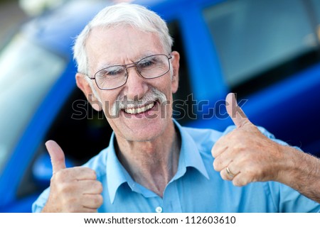 Happy man with his car and thumbs up