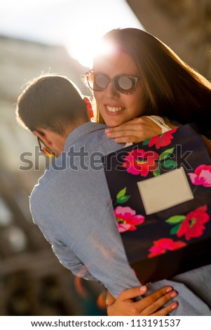 Happy woman thankful for her present hugging her boyfriend