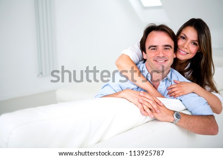 Happy couple smiling at home and hugging