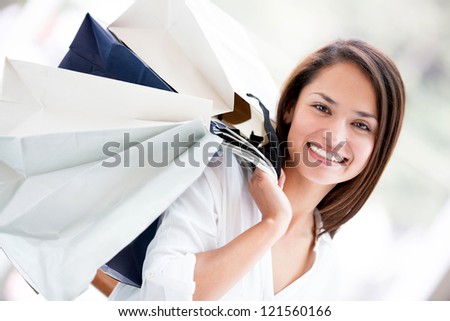 Happy woman holding shopping bags and smiling