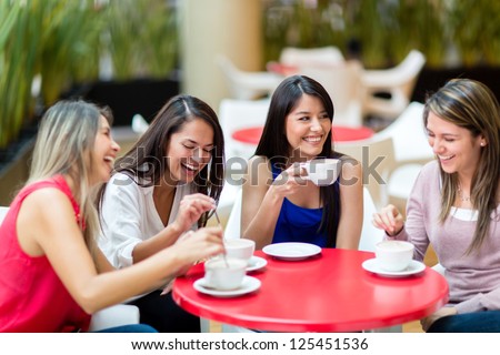 Group of girl friends meeting for coffee and talk