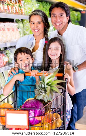 Happy family at the grocery store looking very happy