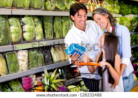 Happy family buying healthy food at the supermarket