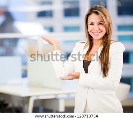 Welcoming business woman looking very happy at the office