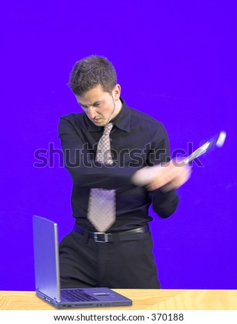angry business man about to destroy his laptop - focus on his furious face