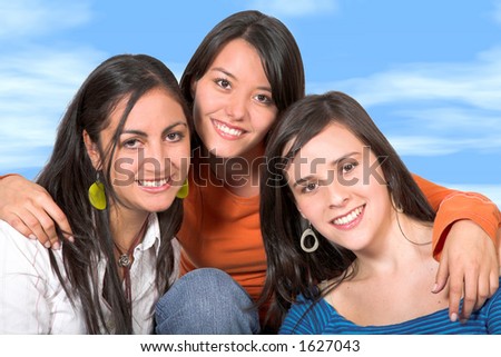 beautiful young girls with the sky in the background - clipping patha included to isolate the girls with high detail in the hair