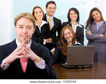 businessman and his business team in an office with a laptop on the desk in middle of a meeting