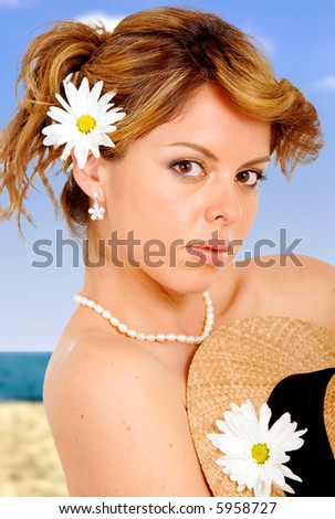 beach fashion girl portrait with daisy flowers on her hair and hat