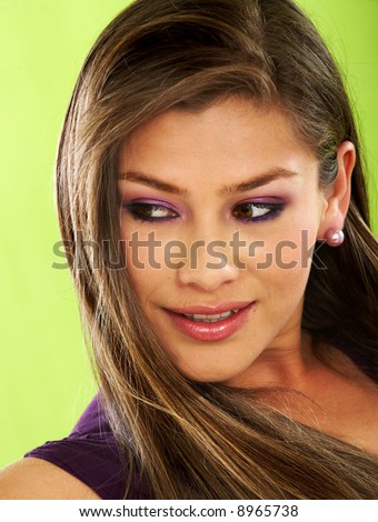 fashion or casual woman portrait giving a big smile - isolated over a green background