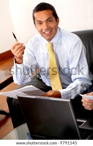 confident business manwith an idea in an office on a laptop computer