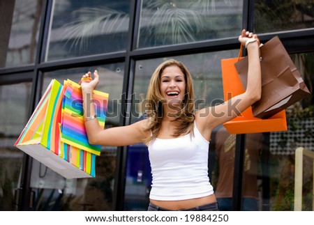 Casual woman with shopping bags in a store smiling