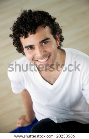 man at the gym portrait smiling and sitting down