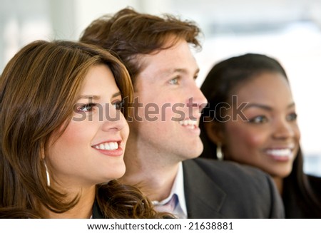 Business people in an office smiling - small team