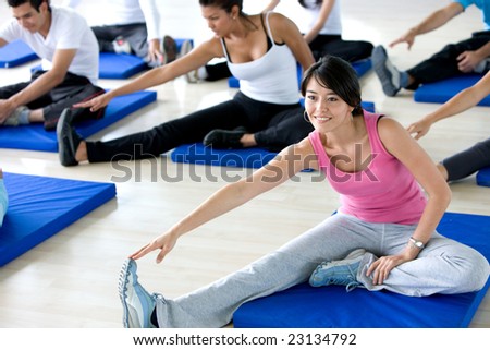 group of gym people in a stretching class