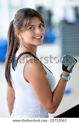 beautiful woman at the gym exercising with free weights