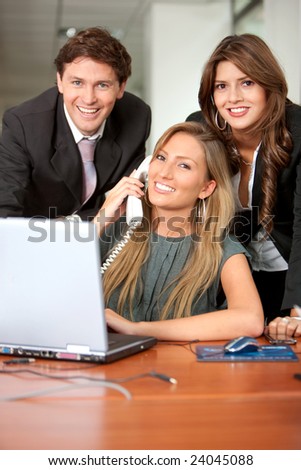 Small team of business people in an office smiling