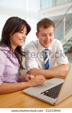 business couple working on a laptop computer at an office