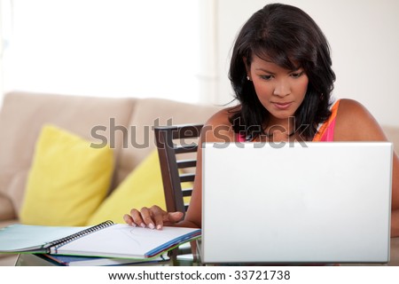 Portrait of a female studying with notebooks and laptop