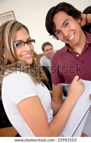 friends or university students smiling in a classroom
