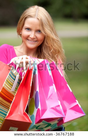 Beautiful woman holding some shopping bags outdoors