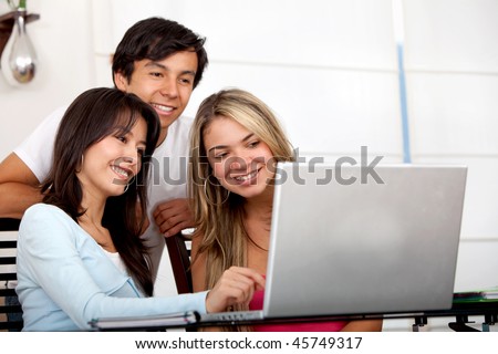 Group of friends working on a computer at home