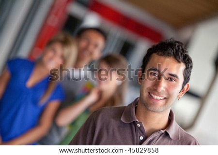 Man at a shopping center with people behind and smiling