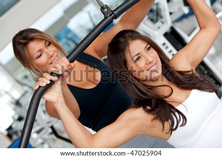 gym woman and her trainer doing exercise at the gym
