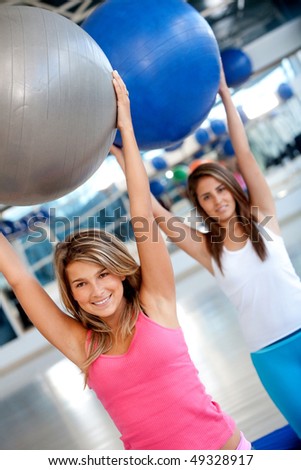 People in aerobics class at the gym with pilates ball