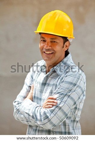 male architect at a construction site smiling
