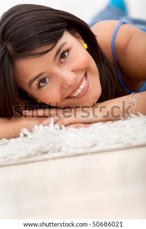 Beautiful woman portrait lying on the floor and smiling