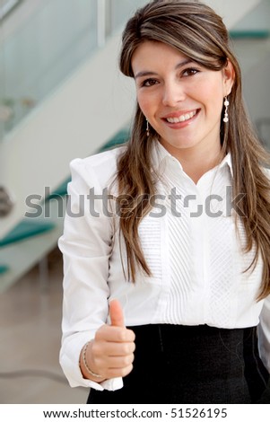 Business woman with thumbs up and smiling