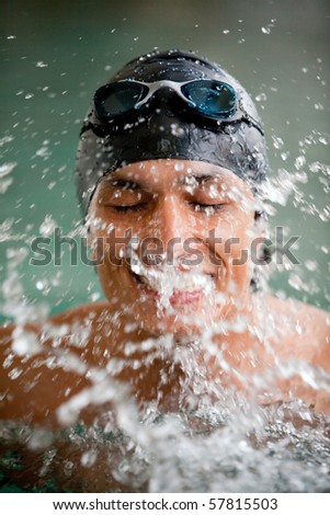 Portrait of a man swimming wearing a cap and goggles