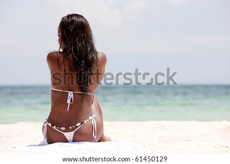 black woman relaxing on the beach while on vacation