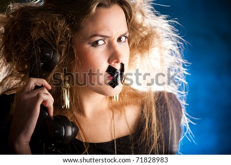 Silenced woman with tape over her mouth holding the phone