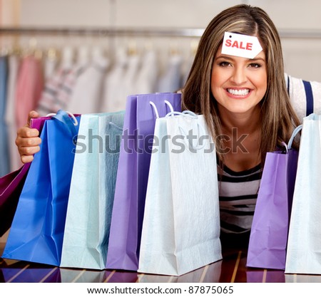 Happy woman with bags shopping on sale