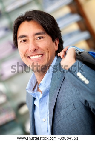 Man shopping at a clothing store and smiling