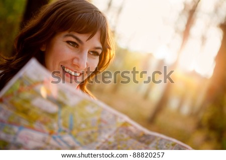 female explorer looking at a map outdoors